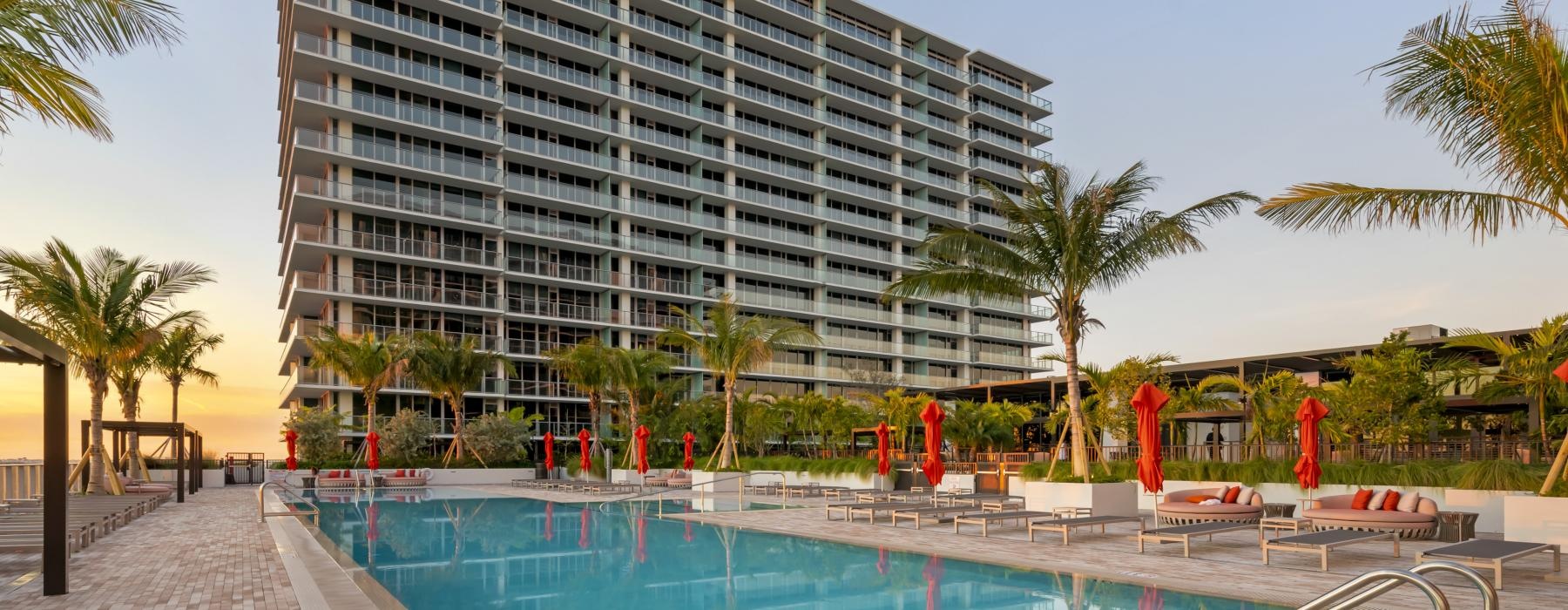 a large building with a pool in front of it