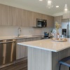 a kitchen with a bar and chairs