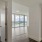 a room with white walls and a wood floor with a large window