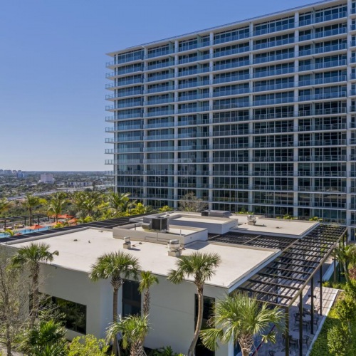 Find your perfect fit at River Landing Residences a tall building with trees and bushes