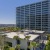 a tall building with trees and bushes