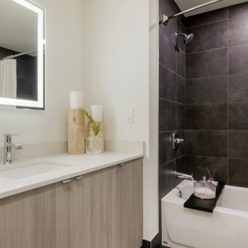 a bathroom with a tub sink and shower