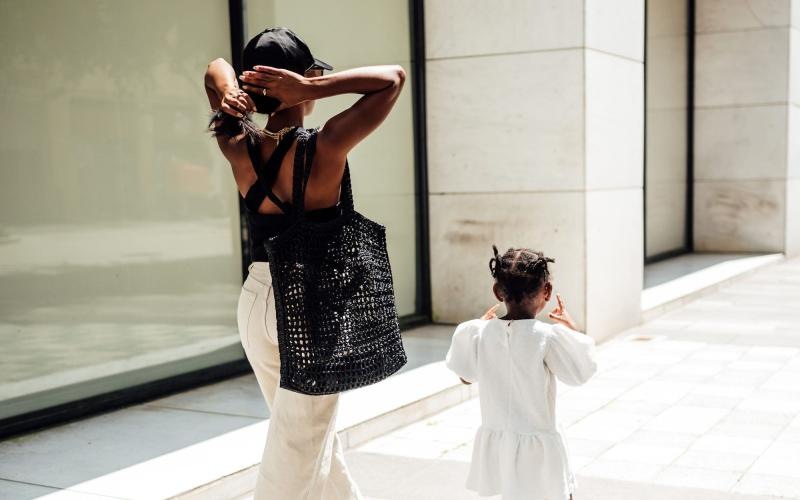 a woman walking with her child