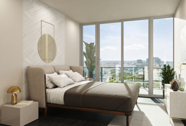 Bedroom with hardwood-style floors, floor to ceiling windows with patio access, and accent wall